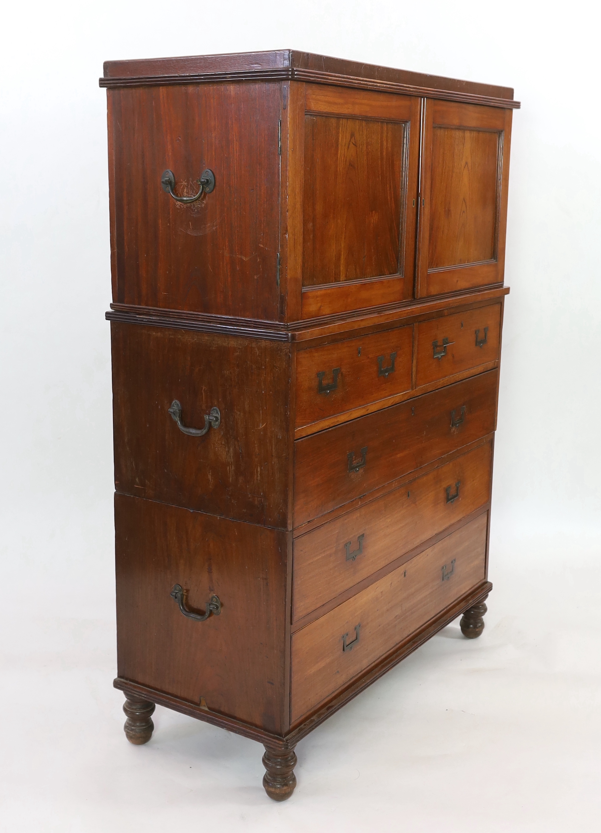 A Victorian teak campaign chest with press cupboard